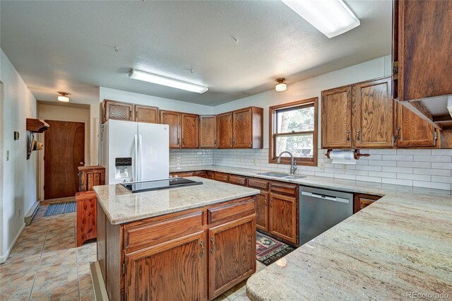 kitchen featuring sink, a center island, stainless steel dishwasher, white refrigerator with ice dispenser, and black electric stovetop