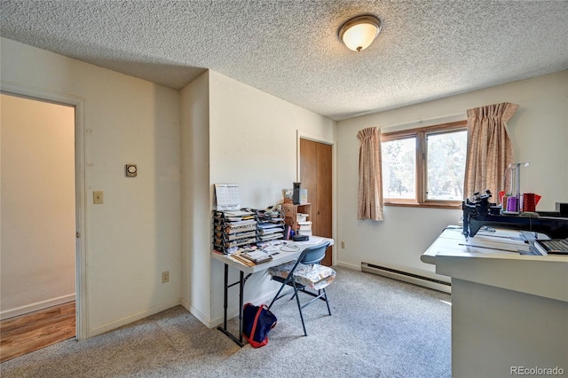 carpeted office space with a textured ceiling and baseboard heating