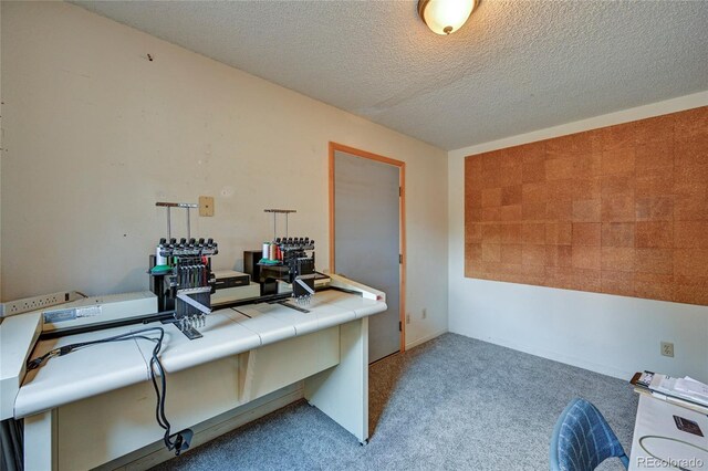 carpeted home office with a textured ceiling