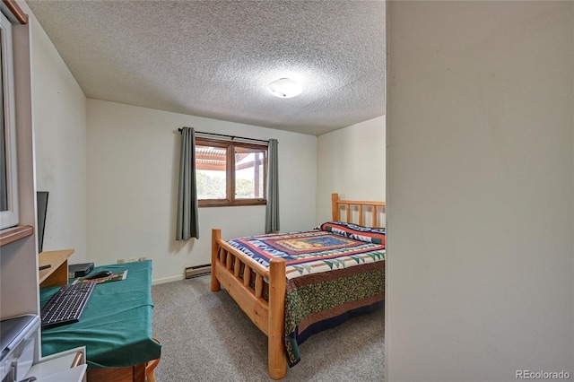 carpeted bedroom with baseboard heating and a textured ceiling