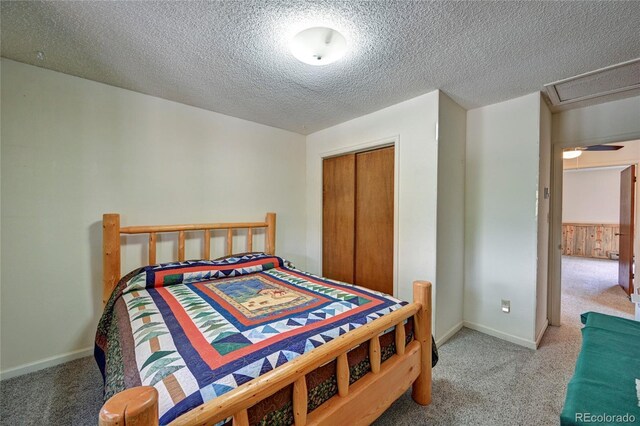 bedroom featuring carpet, a textured ceiling, and a closet