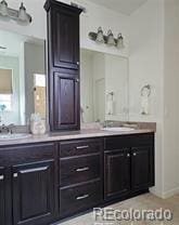 full bath with double vanity and a sink