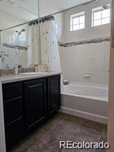 bathroom featuring vanity and shower / tub combo with curtain