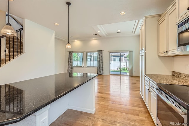 19753 E 54th Ave, Denver, CO 80249 - kitchen featuring cream cabinetry, light wood finished floors, stainless steel appliances, and recessed lighting