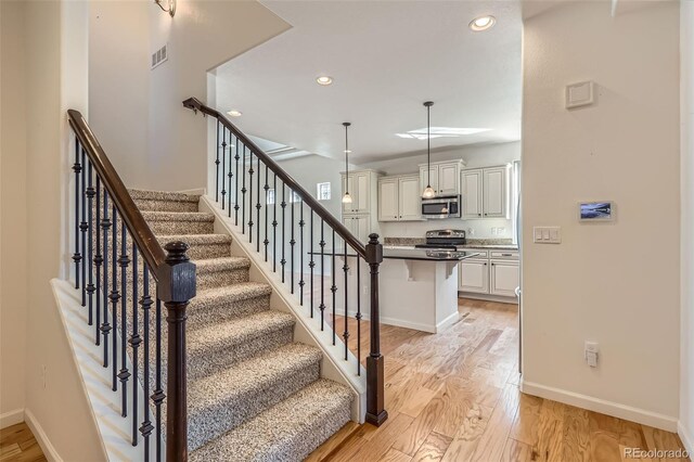 19753 E 54th Ave, Denver, CO 80249 - stairs with wood finished floors and recessed lighting