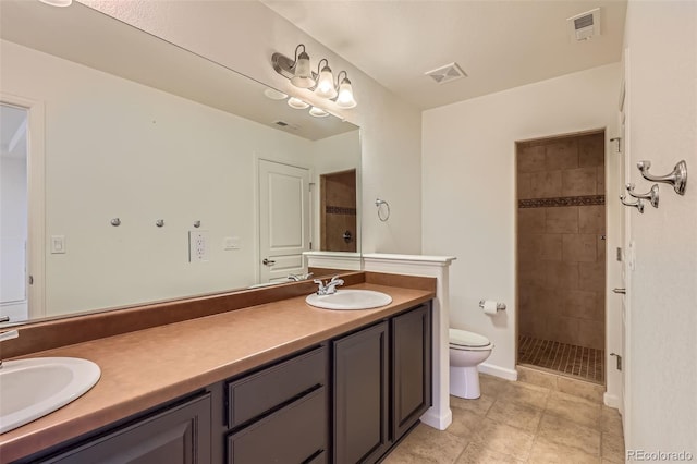 19753 E 54th Ave, Denver, CO 80249 - bathroom with double vanity, a tile shower, and tile patterned flooring