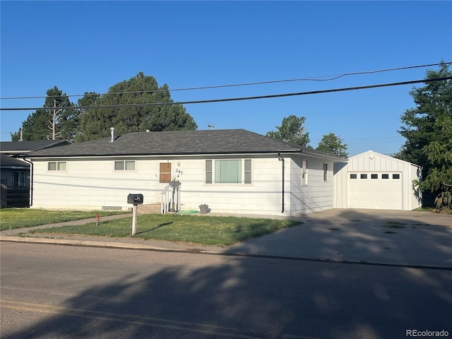 single story home with a garage, an outdoor structure, and a front yard