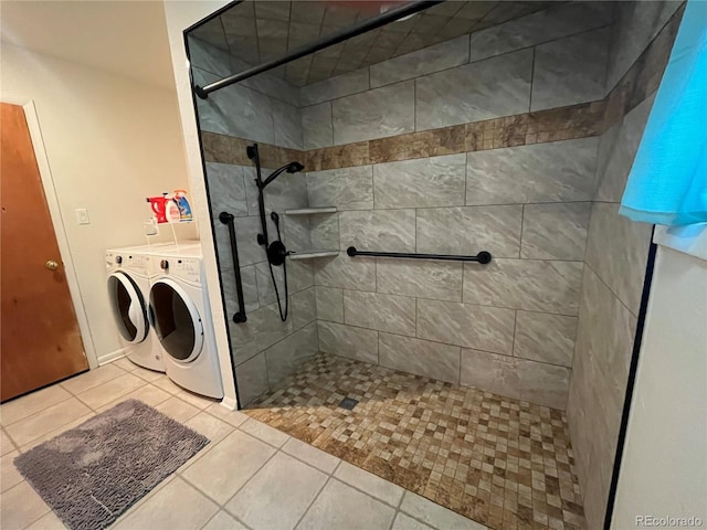 bathroom with washer and dryer, tile patterned floors, and tiled shower