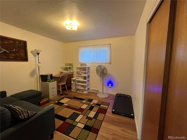 office with a textured ceiling and light hardwood / wood-style flooring