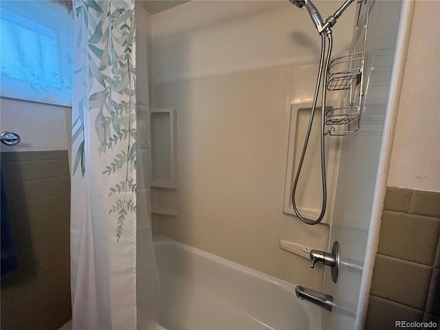 bathroom featuring shower / bath combo with shower curtain