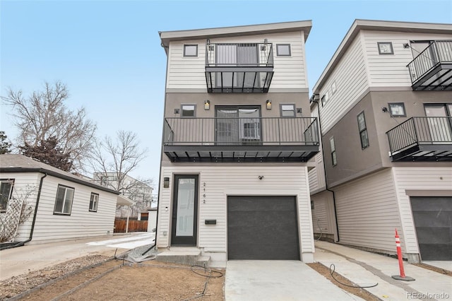 multi unit property featuring a garage and a balcony