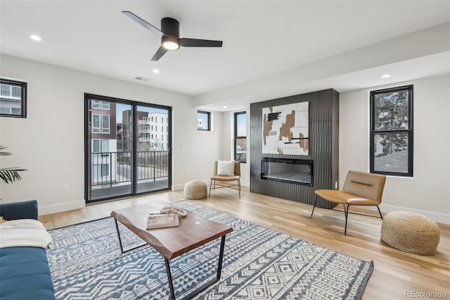 living room featuring hardwood / wood-style flooring and ceiling fan