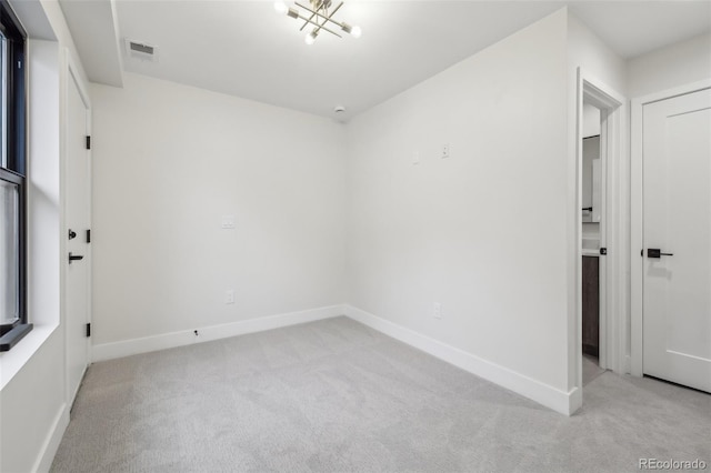 unfurnished room with light carpet