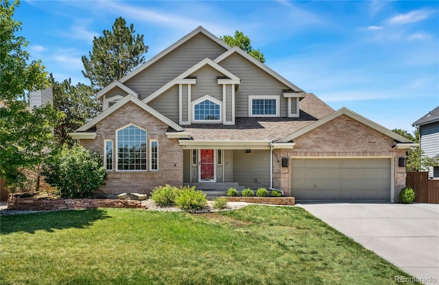 view of front of house with a front yard, concrete driveway, brick siding, and an attached garage