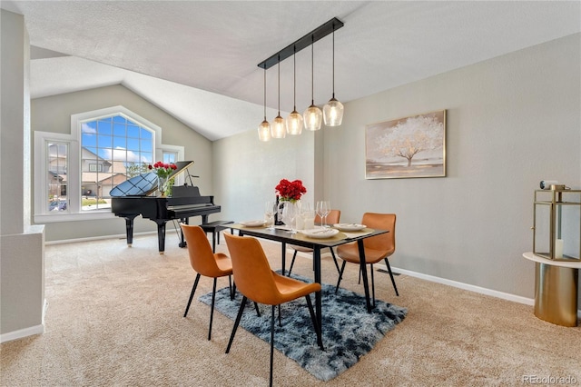 dining space with carpet floors, baseboards, and vaulted ceiling