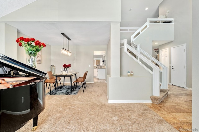 carpeted foyer entrance with stairs and baseboards