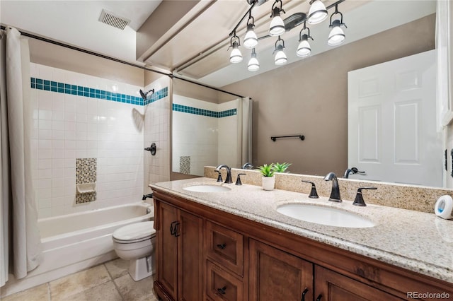 bathroom featuring toilet, visible vents, shower / bath combo with shower curtain, and a sink