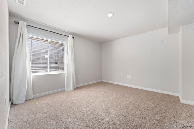 carpeted spare room with recessed lighting, visible vents, and baseboards