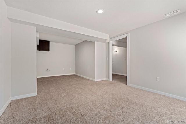 empty room featuring recessed lighting, carpet flooring, visible vents, and baseboards