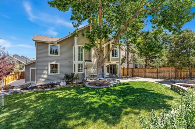 exterior space featuring a lawn, a patio area, and fence