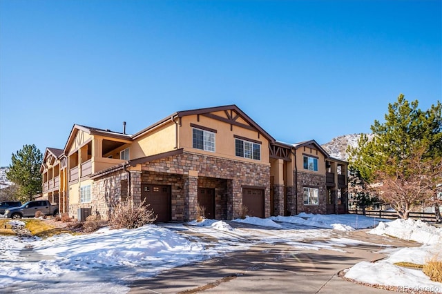 view of front of home with a garage and central AC unit