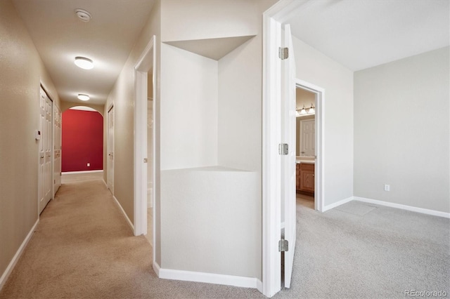 hall featuring light colored carpet