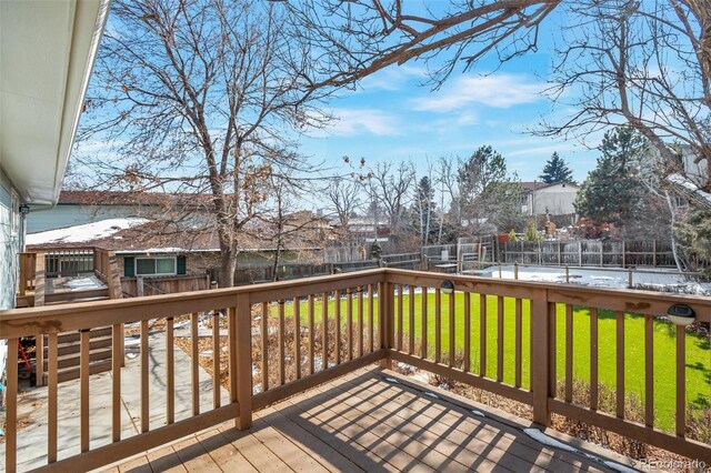 wooden deck with a yard, a fenced backyard, and a residential view