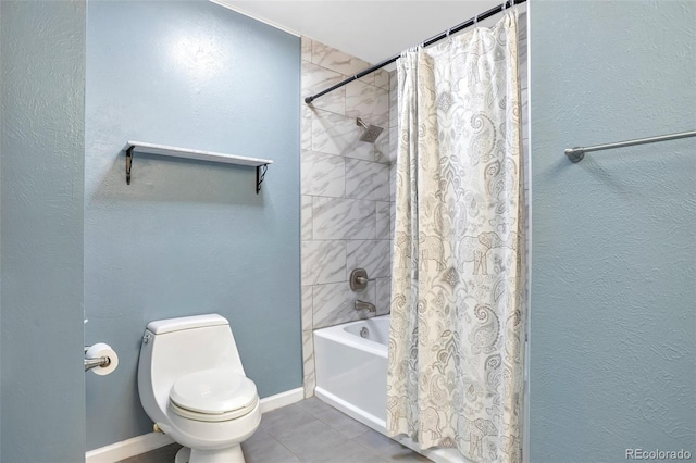 bathroom with toilet, tile patterned flooring, shower / bath combo, and baseboards