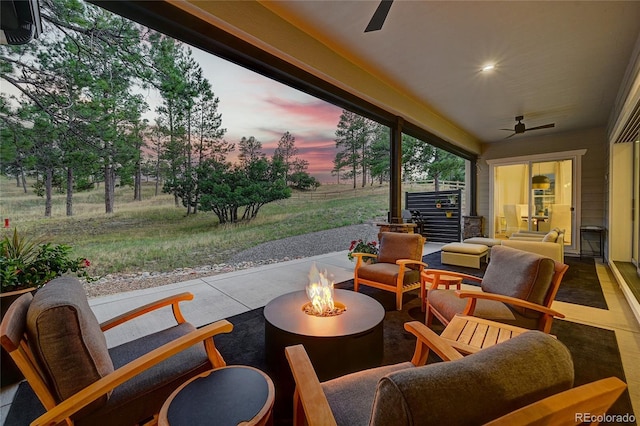 view of patio / terrace with a fire pit and ceiling fan