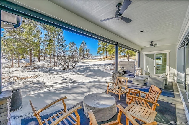 snow covered patio featuring a ceiling fan