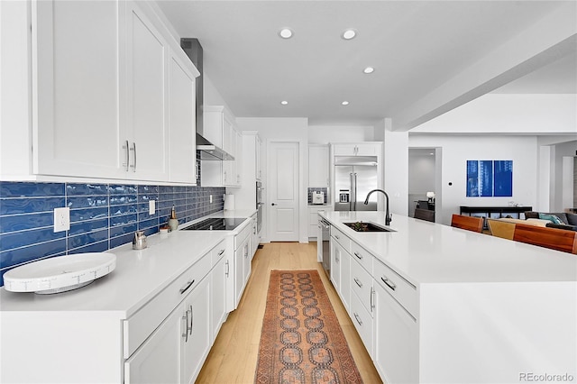 kitchen with a sink, stainless steel appliances, tasteful backsplash, recessed lighting, and white cabinetry