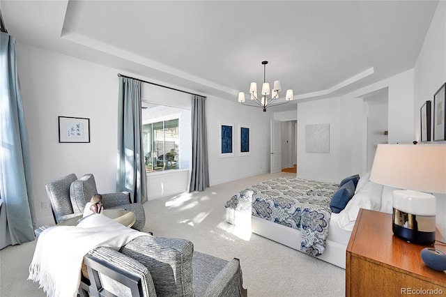 bedroom with a tray ceiling, carpet, and a chandelier
