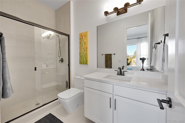 bathroom featuring toilet, a shower stall, and vanity
