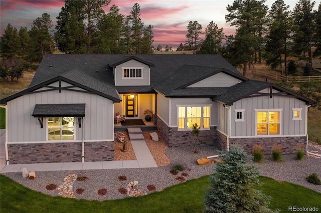9228 Lone Timber Ct, Parker, CO 80134 - view of front of property with board and batten siding, stone siding, and a shingled roof
