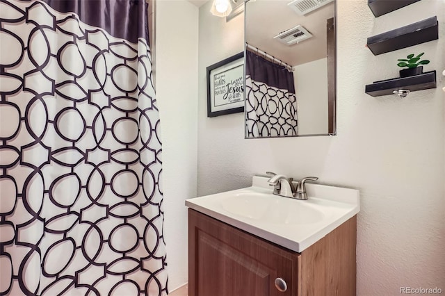 1958 Cathay Ct, Aurora, CO 80011 - full bath with vanity, curtained shower, and a textured wall