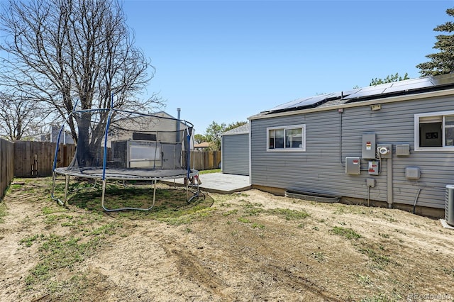 1958 Cathay Ct, Aurora, CO 80011 - fenced backyard with a trampoline and a wooden deck