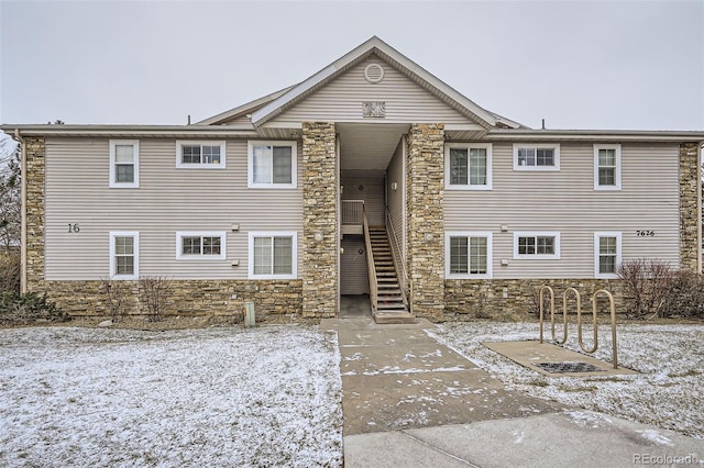 view of snow covered rear of property