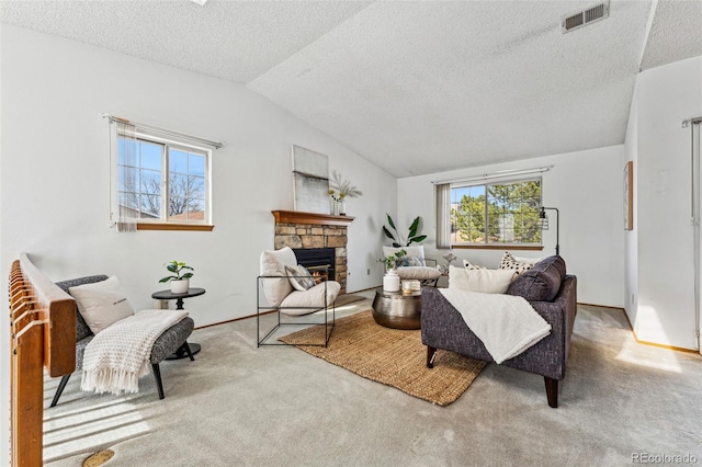 living room featuring visible vents, a stone fireplace, vaulted ceiling, a textured ceiling, and carpet flooring