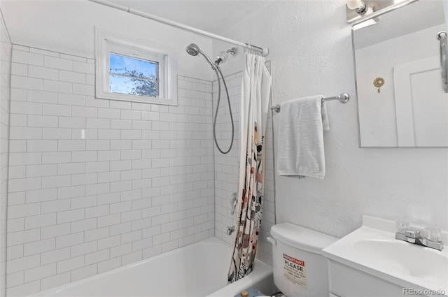 bathroom with shower / tub combo, a textured wall, vanity, and toilet