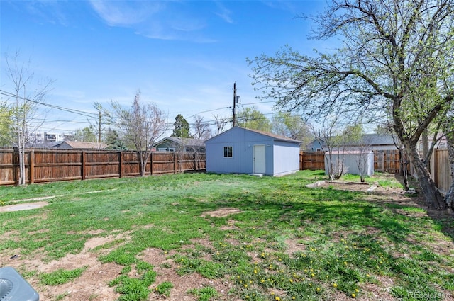 view of yard with an outdoor structure and a fenced backyard