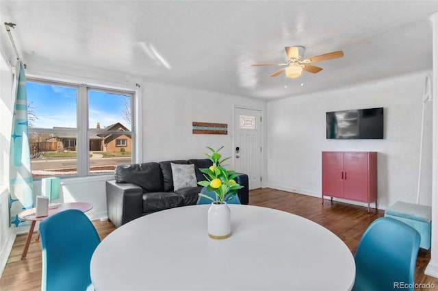 dining area featuring baseboards, wood finished floors, and ceiling fan