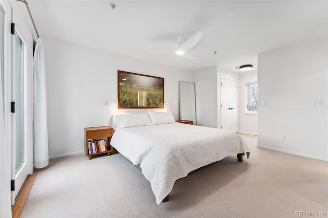 bedroom featuring ceiling fan and light carpet