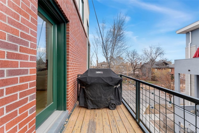 wooden deck featuring a grill