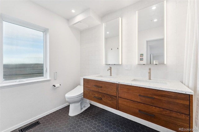 bathroom featuring vanity, tile patterned floors, and toilet