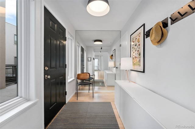 hallway with light hardwood / wood-style flooring