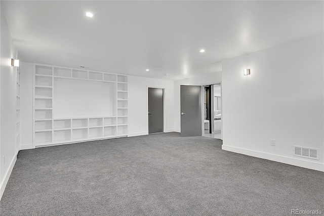 carpeted spare room with built in shelves