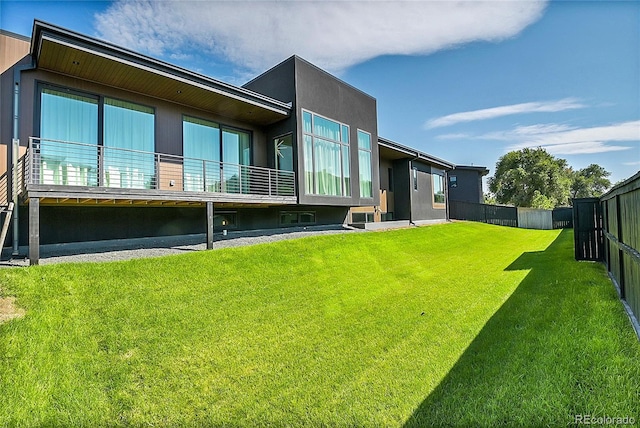 rear view of house featuring a yard