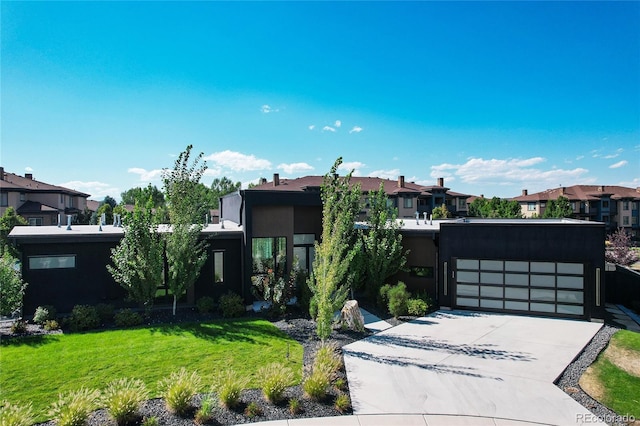 view of front of house with a garage and a front lawn