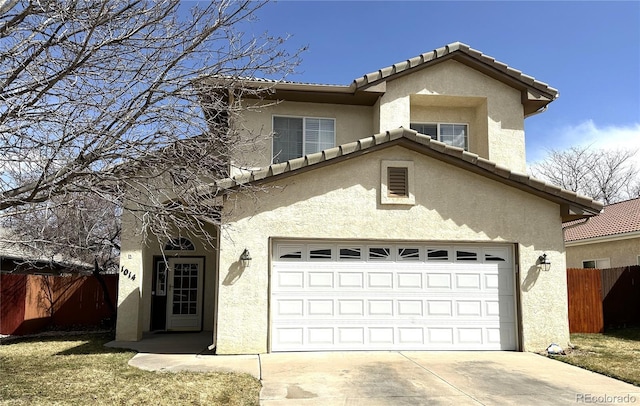 traditional home featuring concrete driveway, stucco siding, a tiled roof, and fence