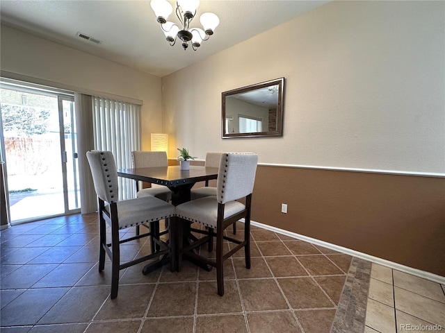 dining room with an inviting chandelier, baseboards, dark tile patterned floors, and visible vents